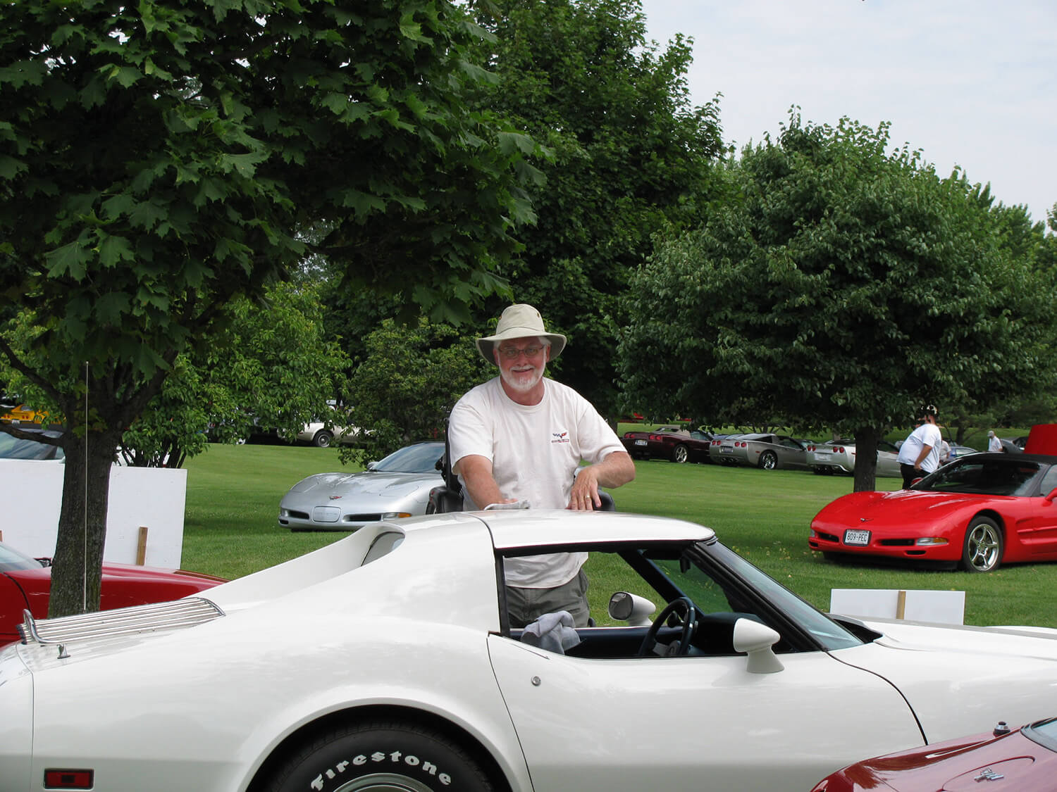 Image of Simon standing with a Corvette at Bloomington Gold